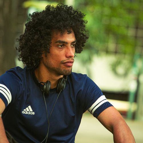 Man in sports wear sitting comfortably outdoors